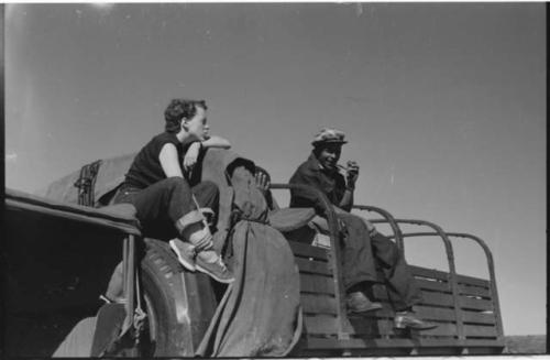 Philip Hameva, Heinrich Neumann and Elizabeth Marshall Thomas sitting on the top of an expedition truck