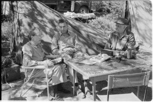 Lorna Marshall, Daniel Blitz and L. F. Maingard sitting in expedition camp at Theunis Berger's farm