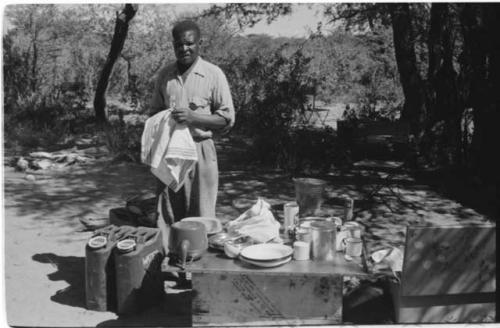 Philip Hameva standing next to his kitchen table at Theunis Berger's farm