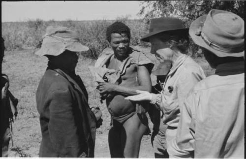 Group of people receiving tobacco from Lorna Marshall