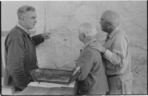 Ernest Midgely, District Commissioner of Ghanzi in his office, with L. F. Maingardand Laurence Marshall