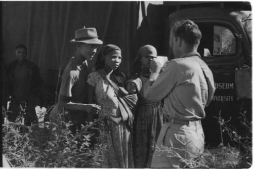 Group of people standing with Daniel Blitz next to an expedition truck