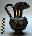 Pottery pitcher, black glazed, stamped