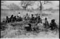 Lorna Marshall, Kernel Ledimo, Elizabeth Marshall Thomas sitting with a group of Ju/'hoansi