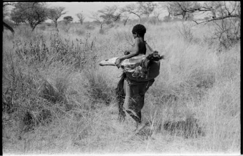 Woman carrying meat in a kaross