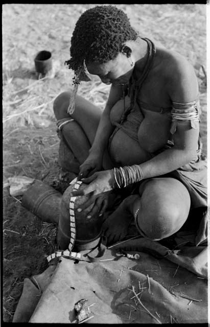 Woman trimming the edge of a leather headband with a knife