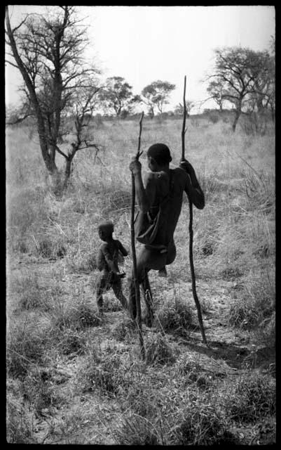 !Kham using sticks as crutches and walking with his son