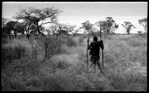 !Kham using sticks as crutches and walking with his son