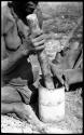 Person using a mortar and pestle, close-up