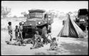 Ju/'hoan youth in front of an expedition truck including an unidentified, visiting girl, !Ungka, the "handmaiden," and N!ai