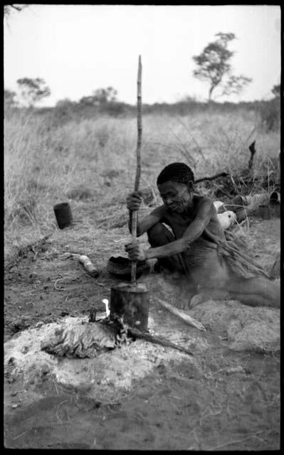 /Naoka (!U's mother) stirring the contents of a pot with a stick