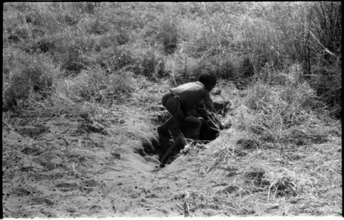 /Gaishay, Bau, and Debe playing in a hole in the ground