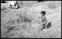 Ju/'hoan boy walking in grass