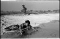 Girl bathing with an unidentified woman in the background