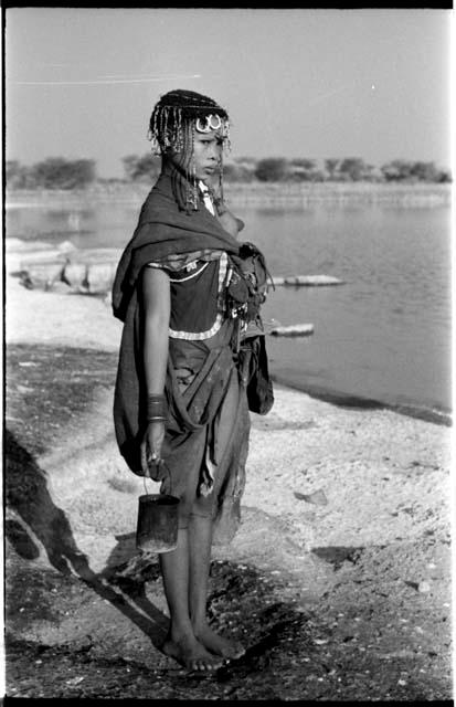 !Ungka's cousin, standing, and holding a tin