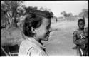 Elizabeth Marshall Thomas wearing a safety-pin earring, with a woman standing in the background