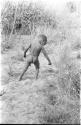 /Gaiamakwe playing with a hoop made from grass, seen from behind