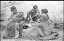 Boys of Oukwane's group and "visiting group" sitting by a fire