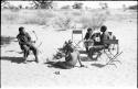 Scene of an interview; left to right: Dabe, Oukwane, Lorna Marshall, Kernel Ledimo, and another unidentified man behind