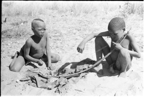 /Gaiamakwe and !Oukabe playing a musical bow