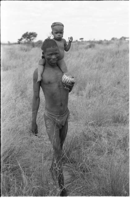 Man carrying a child on his shoulders