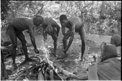 !Gai and two visiting men washing by a fire