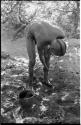 "Visiting man" washing his leg