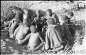 Oukwane's group eating meat, sitting in a cluster