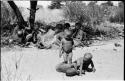 Three little boys playing in the sand