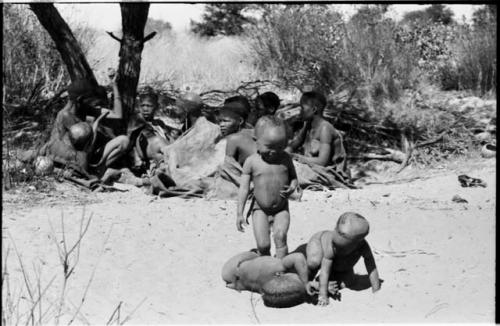 Three little boys playing in the sand