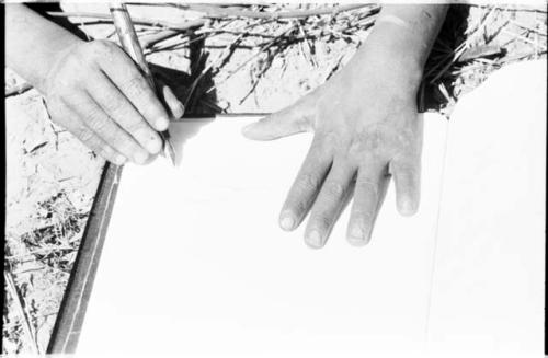 Boy's hand holding a pen