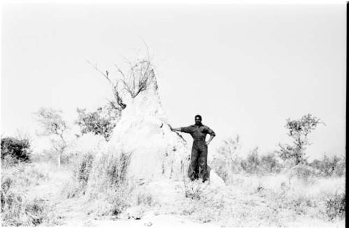 Man standing beside an ant hill