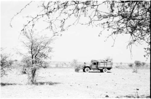 Distant view of the expedition truck, with Lake Ngami in the background