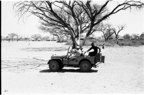 Expedition Jeep in front of a tree