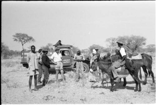 Expedition members meeting a group of local people, with the expedition truck in the background