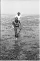 Casper Kruger and Elizabeth Marshall Thomas wading in Lake Ngami