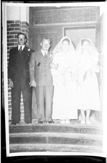 Theunis Berger and Marguerita Ammann at their wedding, accompanied by a bridesmaid and a groomsman, full figure standing