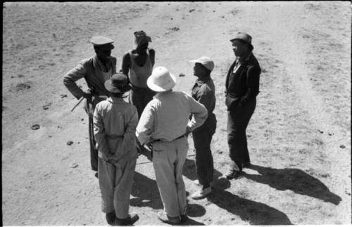 Group of people including Laurence Marshall, Kernel Ledimo, William Donnellan, and Herero people, seen from top of truck