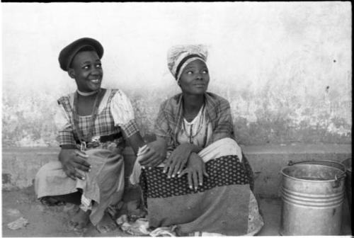 Two women sitting side by side