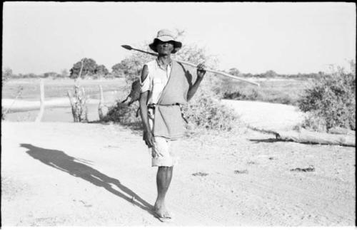 Man holding a spear, full figure standing