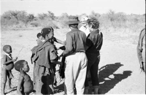 Expedition members, including, Laurence Marshall, Lorna Marshall, and Elizabeth Marshall Thomas, greeted by a group of Ju/'hoansi