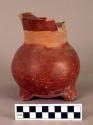 Pottery tripod jar- painted red excepting for a plain strip around neck
