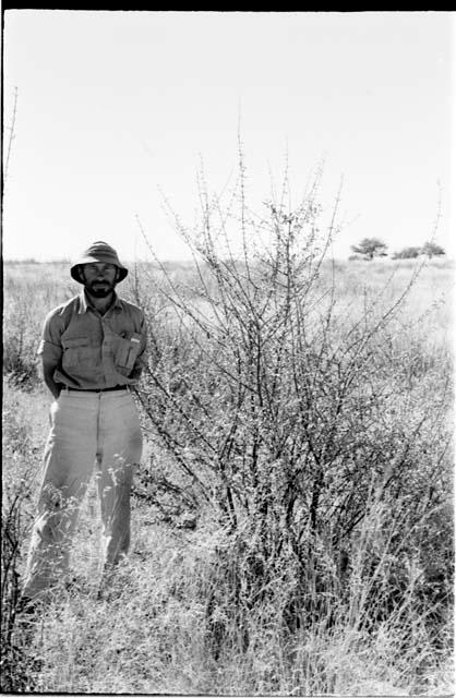 Robert Story standing beside a plant