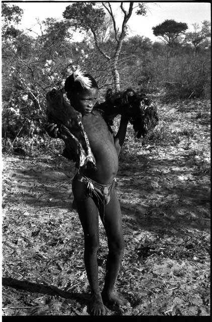 Boy carrying ostrich meat