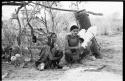 "/Gao Overalls" and woman sitting