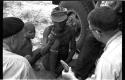 "/Gao Overalls" and a boy sitting with O.P.M. Prozesky and Nicholas England sitting across from him, seen from behind