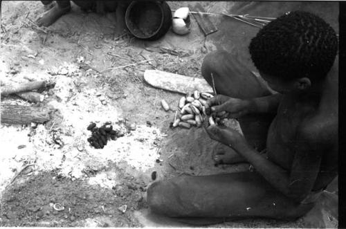 "/Gao Overalls'" son sitting and holding a cocoon