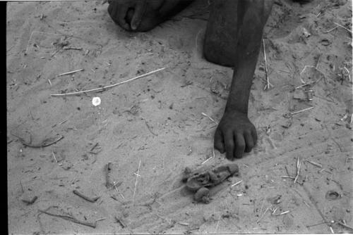 Person's hand next to a toy car