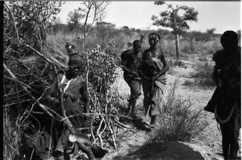 Two women walking and two women standing to the sides, performing a menstruation ceremony