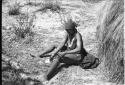 Woman sitting washing herself from a bowl